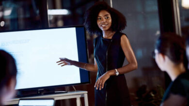 Shot of a young businesswoman delivering a presentation during a late night meeting at work